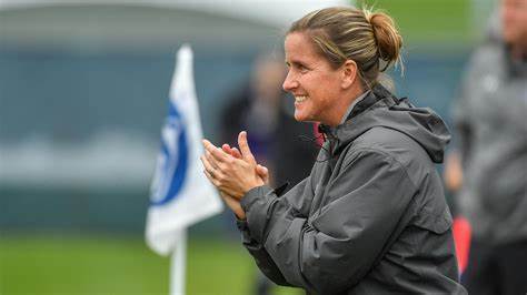 a happy and successful women's Football coach